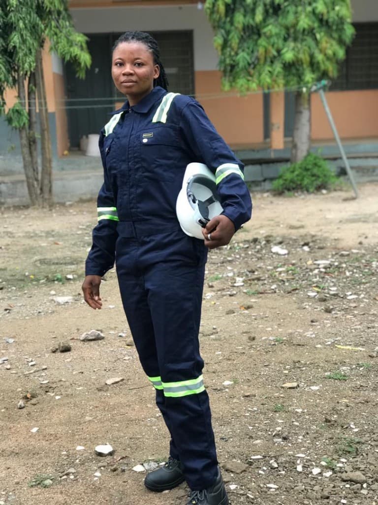 Agricultural professional in safety coveralls supporting farm management operations